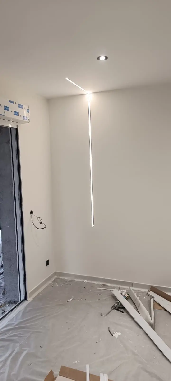 Éclairage décoratif en ruban LED — Marseille. Ruban LED mural posé avec un spot encastré, alimentation tirée et raccordée depuis le tableau.